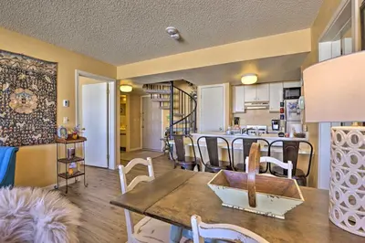 a kitchen and dining room with a table and chairs at Cozy Ski-InandSki-Out Granby Condo with Balcony! in Granby