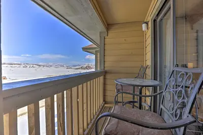a balcony with two chairs and a table on it at Cozy Ski-InandSki-Out Granby Condo with Balcony! in Granby