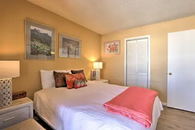 a bedroom with a large white bed with pillows at Cozy Ski-InandSki-Out Granby Condo with Balcony! in Granby