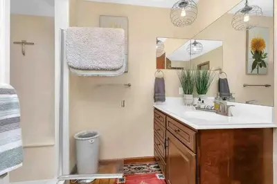 a bathroom with a sink and a mirror and a shower at Panoramic View Home with Hot Tub & Game Room in Black Hawk
