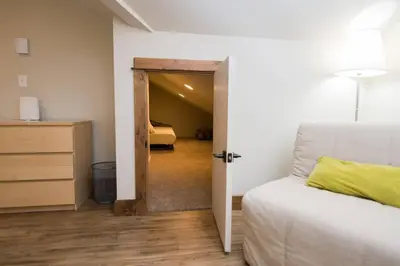 a bedroom with a bed and a door to a bedroom at Sundance-2 miles to Rocky Mountain National Park in Estes Park