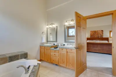 a bathroom with two sinks and a bath tub at Beautiful 7 BEDROOM, 3 gathering areas, pool table, hot tub, and huge deck with 360-degree views!! in Silverthorne