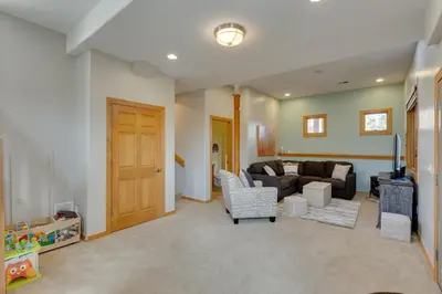 a living room with a couch and a table at Beautiful 7 BEDROOM, 3 gathering areas, pool table, hot tub, and huge deck with 360-degree views!! in Silverthorne