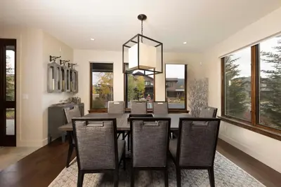 a dining room with a table and chairs at LUXURY HOME by the river! Walk to Shuttle, Hot Tub, Fire Pit, designer finishes!! in Breckenridge