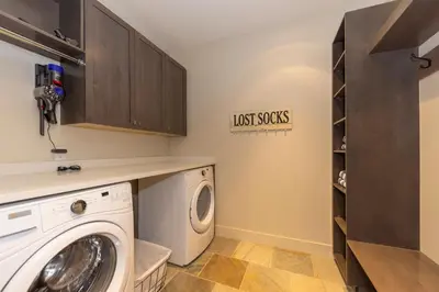 a laundry room with a washer and dryer at LUXURY HOME by the river! Walk to Shuttle, Hot Tub, Fire Pit, designer finishes!! in Breckenridge
