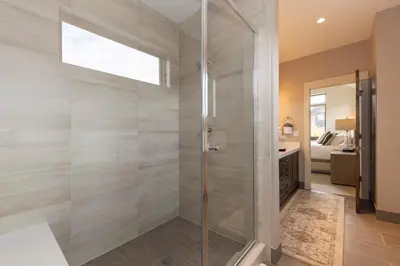 a shower with a glass door in a bathroom at LUXURY HOME by the river! Walk to Shuttle, Hot Tub, Fire Pit, designer finishes!! in Breckenridge