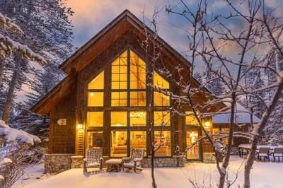 a log cabin in the winter with snow on the ground at Warm, Spacious, and Elegant Breckenridge Home near golf course, hot tub, arcade machine, foosball in Breckenridge