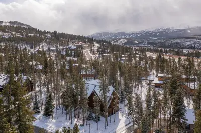 an aerial view of a snow covered mountain with trees at Warm, Spacious, and Elegant Breckenridge Home near golf course, hot tub, arcade machine, foosball in Breckenridge