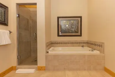 a large bathroom with a tub and a shower at Warm, Spacious, and Elegant Breckenridge Home near golf course, hot tub, arcade machine, foosball in Breckenridge