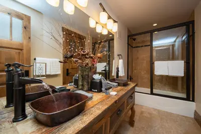 a bathroom with two sinks and a large mirror at Four master suites, VIEWS!! Hot tub, private ski SHUTTLE, sprawling entertaining areas!! in Breckenridge