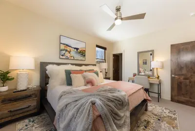 a bedroom with a bed and a ceiling fan at Modern Elegance, Stunning Mountain Views, Hot Tub, Fire Pit, Walk to River! in Breckenridge