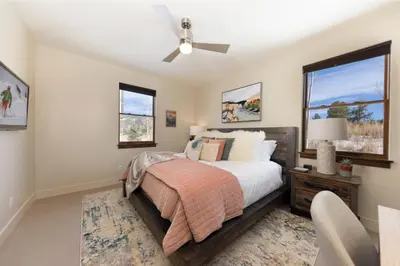a bedroom with a bed and a ceiling fan at Modern Elegance, Stunning Mountain Views, Hot Tub, Fire Pit, Walk to River! in Breckenridge