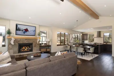 a living room with a couch and a fireplace at Modern Elegance, Stunning Mountain Views, Hot Tub, Fire Pit, Walk to River! in Breckenridge