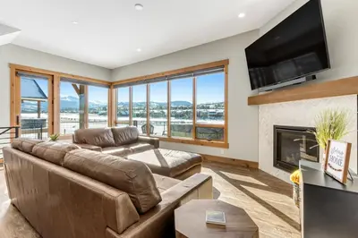 a living room with a couch and a fireplace at Fraser Wonder in Fraser