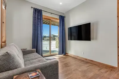 a living room with a couch and a flat screen tv at Fraser Wonder in Fraser
