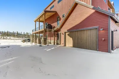 a large red building with a garage in the snow at Fraser Wonder in Fraser