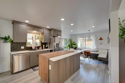 a kitchen with a large island in the middle at Less Than 7 Mi to Dtwn Denver Home with Large Yard! in Denver