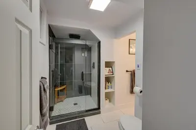 a bathroom with a glass shower with a toilet at Less Than 7 Mi to Dtwn Denver Home with Large Yard! in Denver