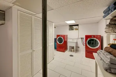 a laundry room with two washing machines and a sink at Less Than 7 Mi to Dtwn Denver Home with Large Yard! in Denver