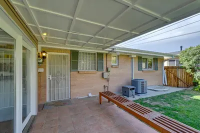awning over a patio with a bench on a porch at Less Than 7 Mi to Dtwn Denver Home with Large Yard! in Denver