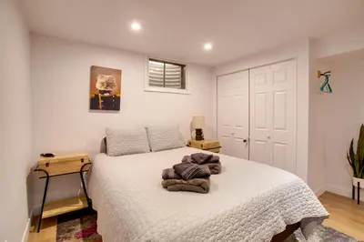 a bedroom with a bed with a white bedspread at Less Than 7 Mi to Dtwn Denver Home with Large Yard! in Denver