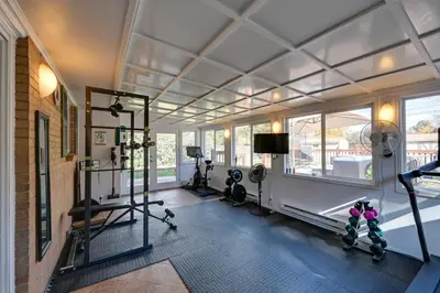 a gym with treadmills and ellipticals in a room with windows at Less Than 7 Mi to Dtwn Denver Home with Large Yard! in Denver