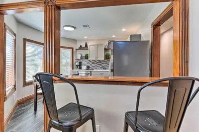 two black chairs at a bar in a kitchen at Deck and Fenced Yard Capitol Hill Townhome in Denver