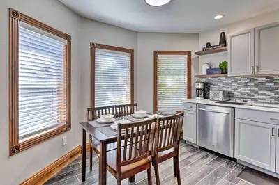 a kitchen with a table and chairs in a room at Deck and Fenced Yard Capitol Hill Townhome in Denver