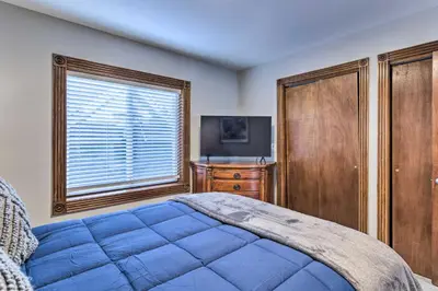 a bedroom with a bed and a dresser and a window at Deck and Fenced Yard Capitol Hill Townhome in Denver