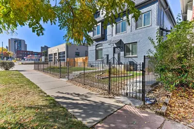 a fence in front of a house at Deck and Fenced Yard Capitol Hill Townhome in Denver