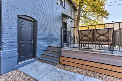 a blue building with a door and two chairs on a balcony at Deck and Fenced Yard Capitol Hill Townhome in Denver