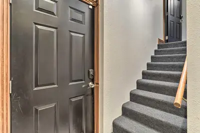 a door leading up to a staircase with a gray carpet at Less Than 1 Mi to St Josephs Denver Townhome! in Denver