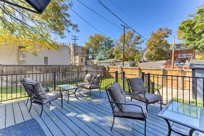 a patio with chairs and a table and a fence at Less Than 1 Mi to St Josephs Denver Townhome! in Denver