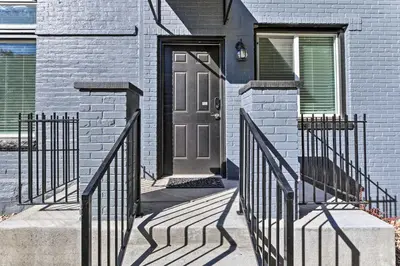 a front door of a house with a gray door at Less Than 1 Mi to St Josephs Denver Townhome! in Denver