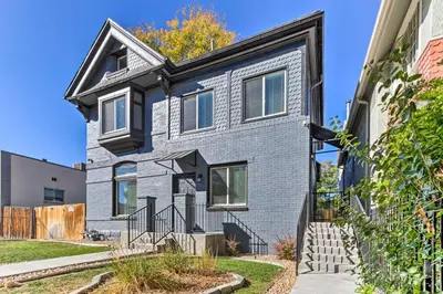 a gray brick house with a black roof at Less Than 1 Mi to St Josephs Denver Townhome! in Denver