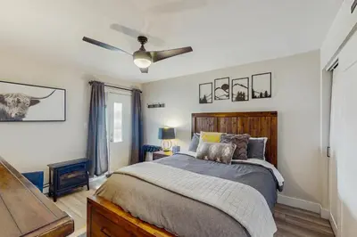 a bedroom with a bed and a ceiling fan at Winter Park Lodge II #104 in Fraser