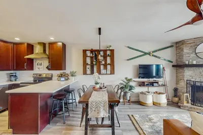 a kitchen with a table and some chairs in a room at Winter Park Lodge II #104 in Fraser