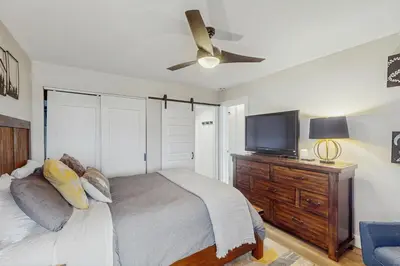 a bedroom with a bed and a flat screen tv at Winter Park Lodge II #104 in Fraser