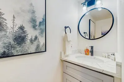 a bathroom with a sink and a mirror at Winter Park Lodge II #104 in Fraser