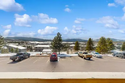 a parking lot with several cars parked in it at Winter Park Lodge II #104 in Fraser