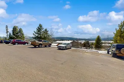 a parking lot with cars parked on the side of the road at Winter Park Lodge II #104 in Fraser