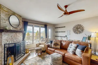 a living room with a couch and a fireplace at Winter Park Lodge II #104 in Fraser