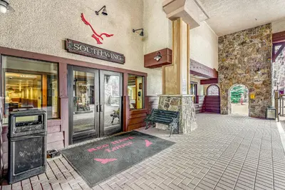a store front with a bench in front of a building at Red Hawk 2276 in Keystone
