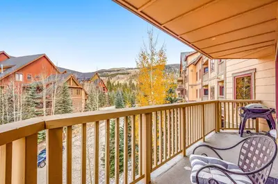 a balcony with two chairs and a table at Red Hawk 2276 in Keystone