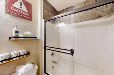 a bathroom with a shower with a glass door at Wish Upon a Morningstar in Frisco