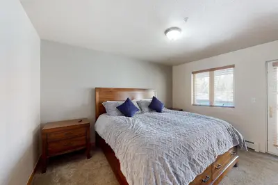 a bedroom with a large bed with blue pillows at Wish Upon a Morningstar in Frisco