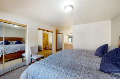 a bedroom with a large bed and a mirror at Wish Upon a Morningstar in Frisco