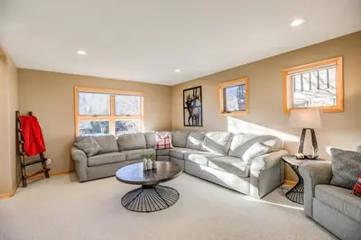 a living room with two couches and a table at Crossroads Nordic Townhome: Spacious, On Bike Path in Frisco