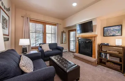 a living room with a couch and a fireplace at Zephyr Mountain Lodge Premium-Rated 2108 in Winter Park