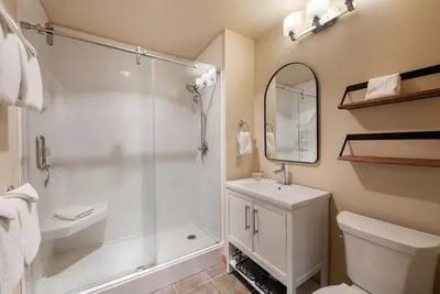 a bathroom with a shower and a toilet and a sink at Zephyr Mountain Lodge Premium-Rated 2108 in Winter Park